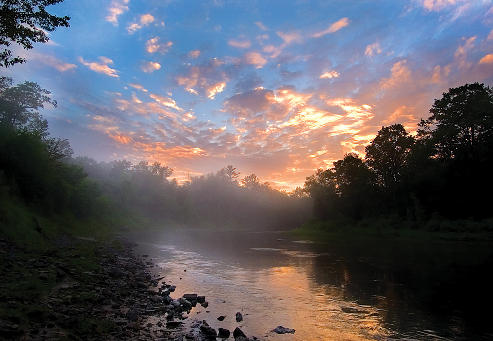 The sun sets over the Au Sable River