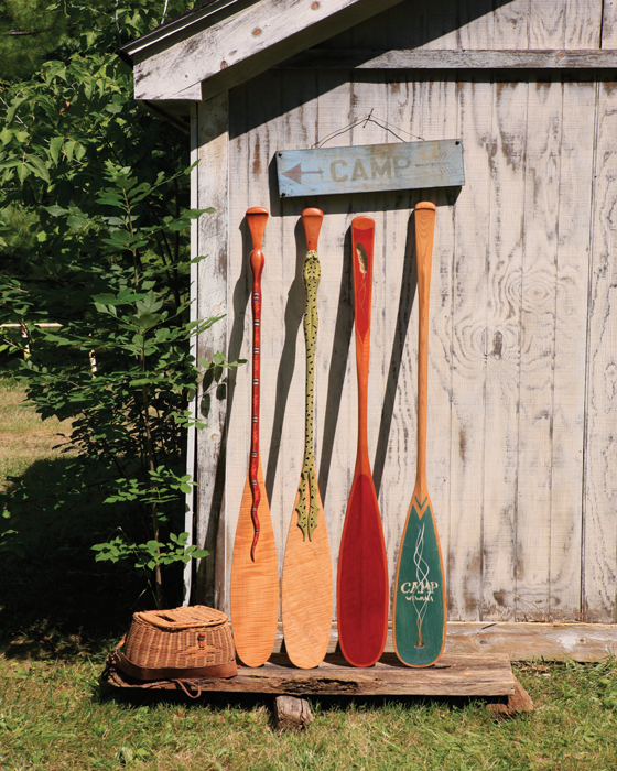 Paddles Standing Against Cabin