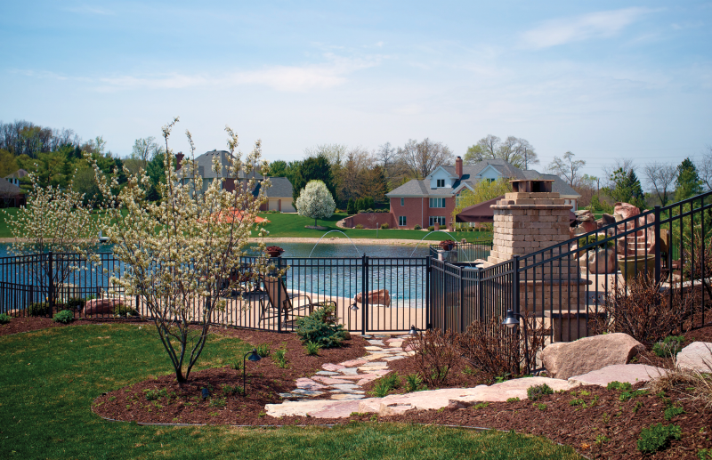 Backyard with pool with a waterslide and patio