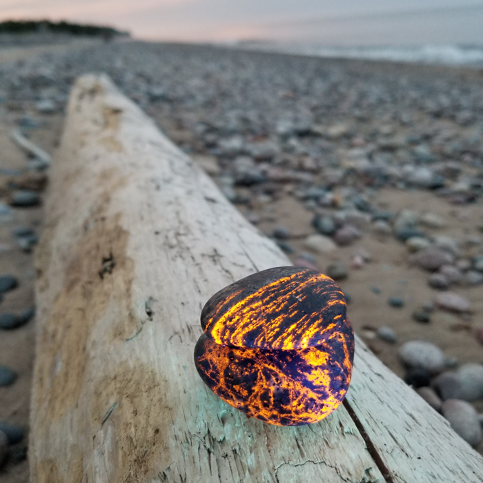 Upper Peninsula rockhound Erik Rintamaki discovered rocks that glow under ultraviolet light on a Lake Superior shoreline at night while searching for agates.