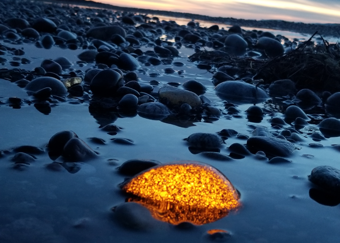 Upper Peninsula rockhound Erik Rintamaki discovered rocks that glow under ultraviolet light on a Lake Superior shoreline at night while searching for agates.