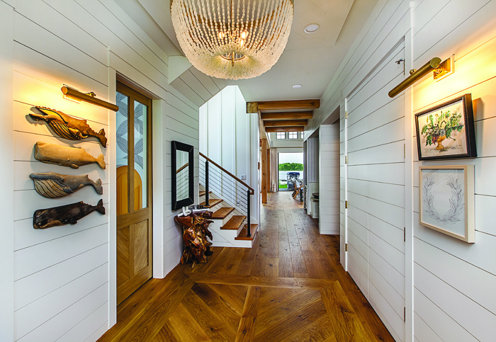 A shiplap-chic hallway; the master bath (unique caning stars in the cabinetry); and the master bedroom, which features vaulted ceilings with exposed beams. 